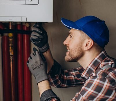 Service man adjusting house heating system